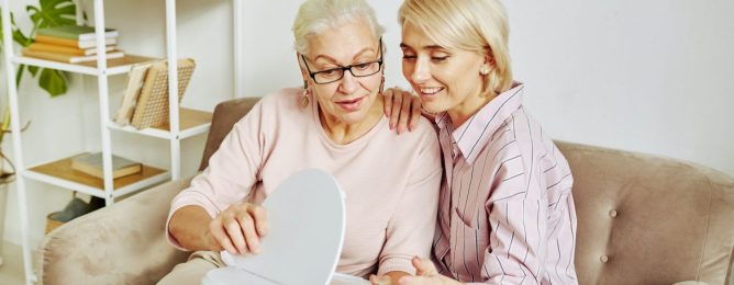 senior-woman-holding-smart-vacuum-cleaner.jpg