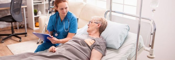 senior-woman-lying-in-nursing-home-bed.jpg