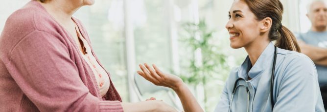 senior-woman-talking-to-caring-nurse-at-waiting-room.jpg